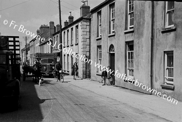 NARROW STREET WITH TURF LORRY